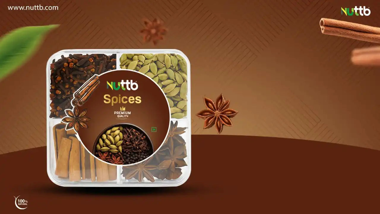 A clear, four-compartment container of whole spices including star anise, cardamom, cinnamon sticks, and black peppercorns.